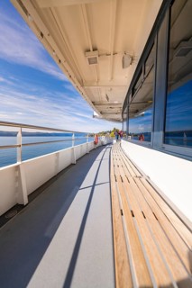 Empty ship deck with sea view under clear blue sky, boat trip, Lake Constance, Germany