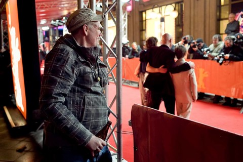DEU, Germany, Berlin Man with beer in hand watches the hustle and bustle on the red carpet in front