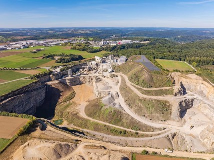 A large quarry with surrounding fields and forests from the air, Nagold, Black Forest, Germany
