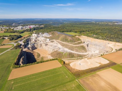 View of a large quarry with surrounding fields and forests, Nagold, Black Forest, Germany
