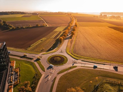 Extensive landscape with roundabout and fields, colored in autumn at sunset, Nagold, Black Forest,