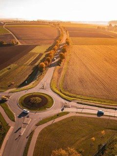 Aerial view of a roundabout surrounded by autumn fields in the evening light, Nagold, Black Forest,
