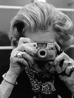 DEU, Germany, Berlin, 22.11.1999. An elderly woman takes pictures during an exhibition opening in