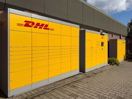 Large DHL packing station in typical yellow color with red logo, Germany