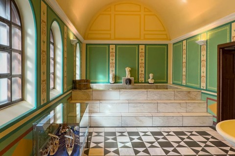 View of reconstructed Roman ancient Roman caldarium hot bath heating room with hot water pool under