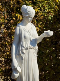 Statue of in Greek mythology goddess of youth Hebe Roman goddess Iuventas of male youth holding a