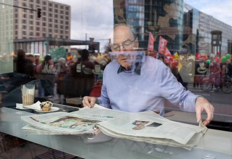 Germany Berlin Anti-nuclear power demonstration in Berlin Mitte. Visitor reads newspapers in a