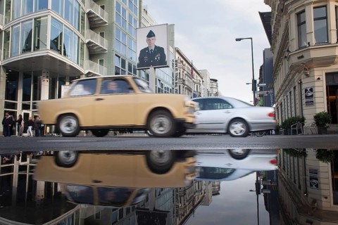 DEU Germany Germany Berlin Trabbi at Checkpoint Charlie with reflection in a puddle after rain