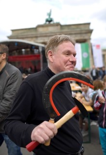 GERMANY A man carries a hammer and sickle in his hand at the DGB rally on May 1. Germany Berlin A