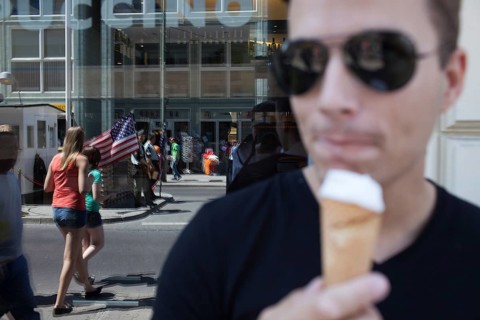DEU Germany Germany Berlin tourist with ice cream at Checkpoint Charlie