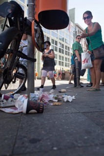 DEU Germany Germany Berlin tourist points to defective trash can at Checkpoint Charlie