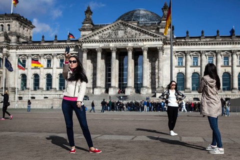 DEU Germany Germany Berlin Kazakh tourists take pictures of themselves in front of the Reichstag