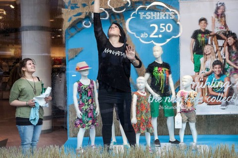 DEU Germany Germany Berlin employees clean a shop window in which the spring collection is on