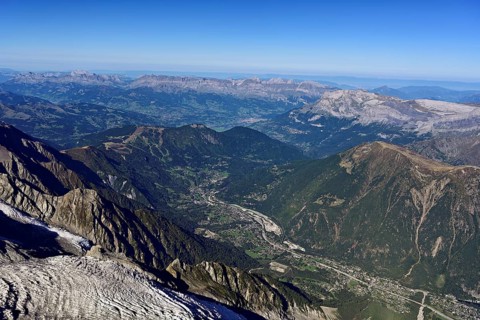 View from the Aiguille du Midi mountain station observation deck into the valley with the city,