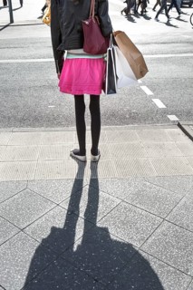 DEU Germany Germany Berlin A woman with shopping bags waits at a pedestrian traffic light on