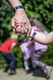 DEU Germany Germany Pattensen Old hand holding young hand in a multi-generation house in Pattensen