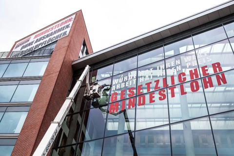 DEU Germany Germany Berlin Window cleaner on the façade of the Verdi headquarters, where an