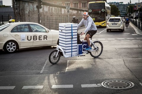 DEU Germany Germany Berlin courier driver traveling with cargo bike in the capital