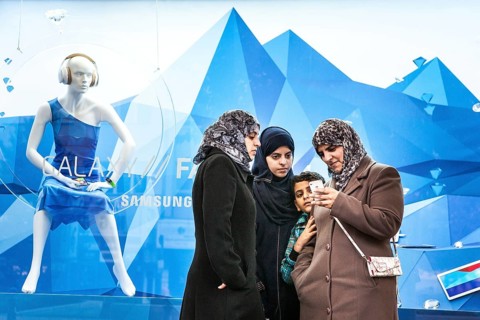 DEU Germany Germany Berlin Women wearing headscarves look at an Apple iPhone. You are standing in
