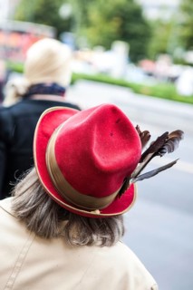 DEU Germany Germany Berlin Woman wearing red hat decorated with feathers