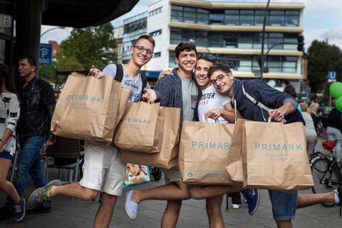 DEU Germany Germany Berlin Young Italian tourists pose with their Primark bags on Schlossstraße in