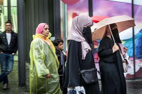 DEU Germany Germany Berlin Women wearing headscarves and face veils walking through the rain on