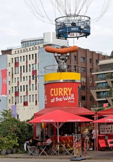 Curry at the Wall snack bar with passengers in the HiFlyer World Balloon, bizarre scene,