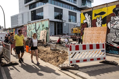 DEU Germany Germany Berlin Tourists pass through the opening in the East-Side Gallery, which was