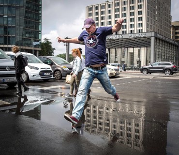 DEU Germany Germany Berlin Pedestrians jump over a cap at Potsdamer Pltz