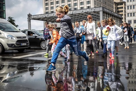 DEU Germany Germany Berlin Pedestrians jump over a cap at Potsdamer Pltz