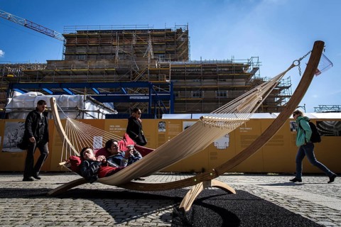 DEU Germany Germany Berlin Tourists sunbathe in a hammock not far from the Staatsoper Unter den