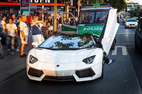 DEU Germany Germany Berlin A Lamborghini sports car is observed or photographed by passers-by on