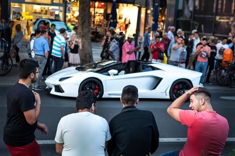 DEU Germany Germany Berlin A Lamborghini sports car is observed or photographed by passers-by on