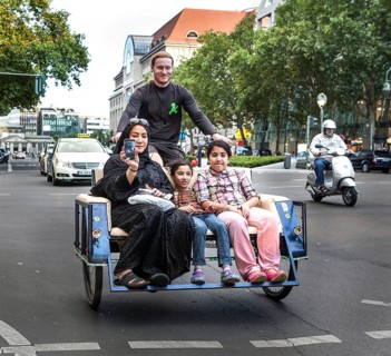 DEU Germany Germany Berlin A woman rides over Tauentzien in a rickshaw with her children
