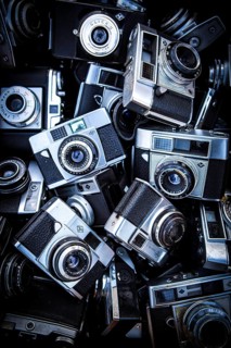 DEU Germany Germany Berlin Analog viewfinder cameras are on display by a salesman at the flea