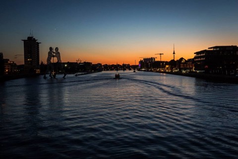 DEU Germany Germany Berlin View over Osthafen across the Spree towards Alex at sunset