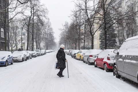 DEU Germany Germany Berlin Walking on snow-covered road in Schöneberg