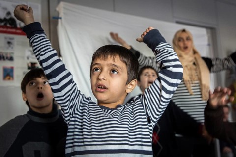 DEU Germany Germany Berlin An animation team entertains refugee children in an asylum center in