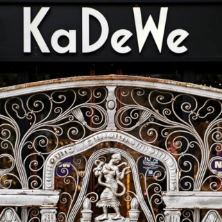 KaDeWe logo, Kaufhaus des Westens, with old forged grid in front of the entrance when the shop is