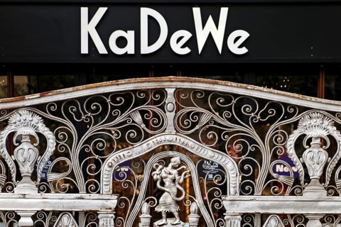 KaDeWe logo, Kaufhaus des Westens, with old forged grid in front of the entrance when the shop is