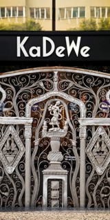 KaDeWe logo, Kaufhaus des Westens, with old forged grid in front of the entrance when the shop is