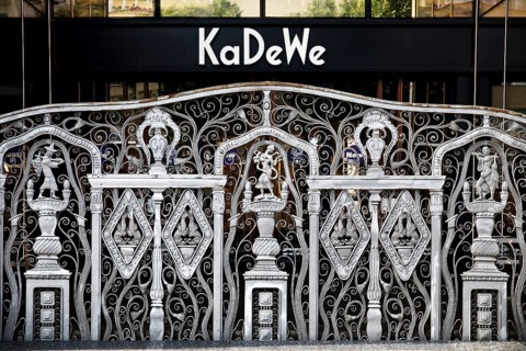 KaDeWe logo, Kaufhaus des Westens, with old forged grid in front of the entrance when the shop is