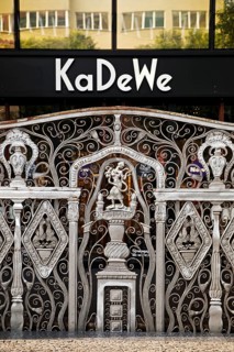 KaDeWe logo, Kaufhaus des Westens, with old forged grid in front of the entrance when the shop is
