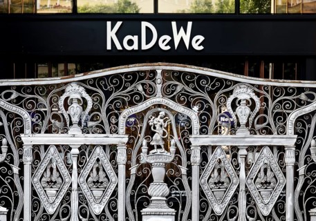 KaDeWe logo, Kaufhaus des Westens, with old forged grid in front of the entrance when the shop is