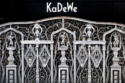 KaDeWe logo, Kaufhaus des Westens, with old forged grid in front of the entrance when the shop is