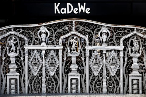 KaDeWe logo, Kaufhaus des Westens, with old forged grid in front of the entrance when the shop is