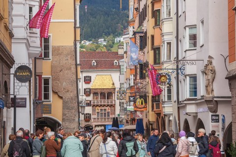 Golden roof, lots of people and historic houses in Herzog-Friedrich-Straße, Altstadt, Innsbruck,