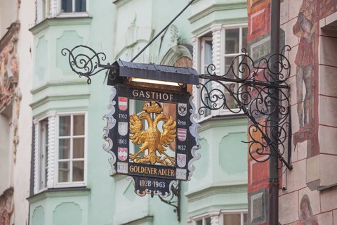 Old hanging sign from Gasthof Goldener Adler in Herzog-Friedrich-Straße, Old Town, Innsbruck,