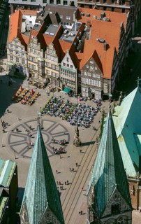 Hanseatic cross in front of the Bremen Roland on the market square of Bremen in front of the town