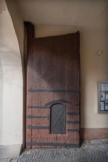 Left side of the wooden gate with manhole at the entrance to the fortified church, around 1500,